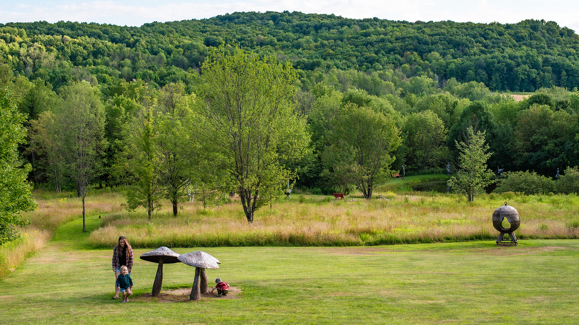 Mom and kids at the Mushrooms and Bathesphere at the lower main area of Griffis Sculpture Park