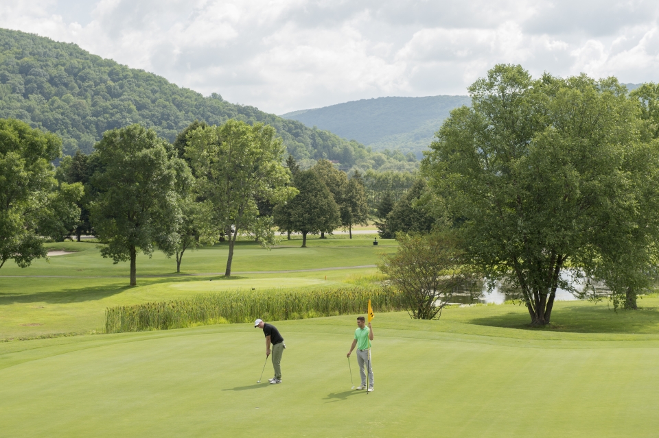 Guys golfing on Double Black Diamond golf course at Holiday Valley