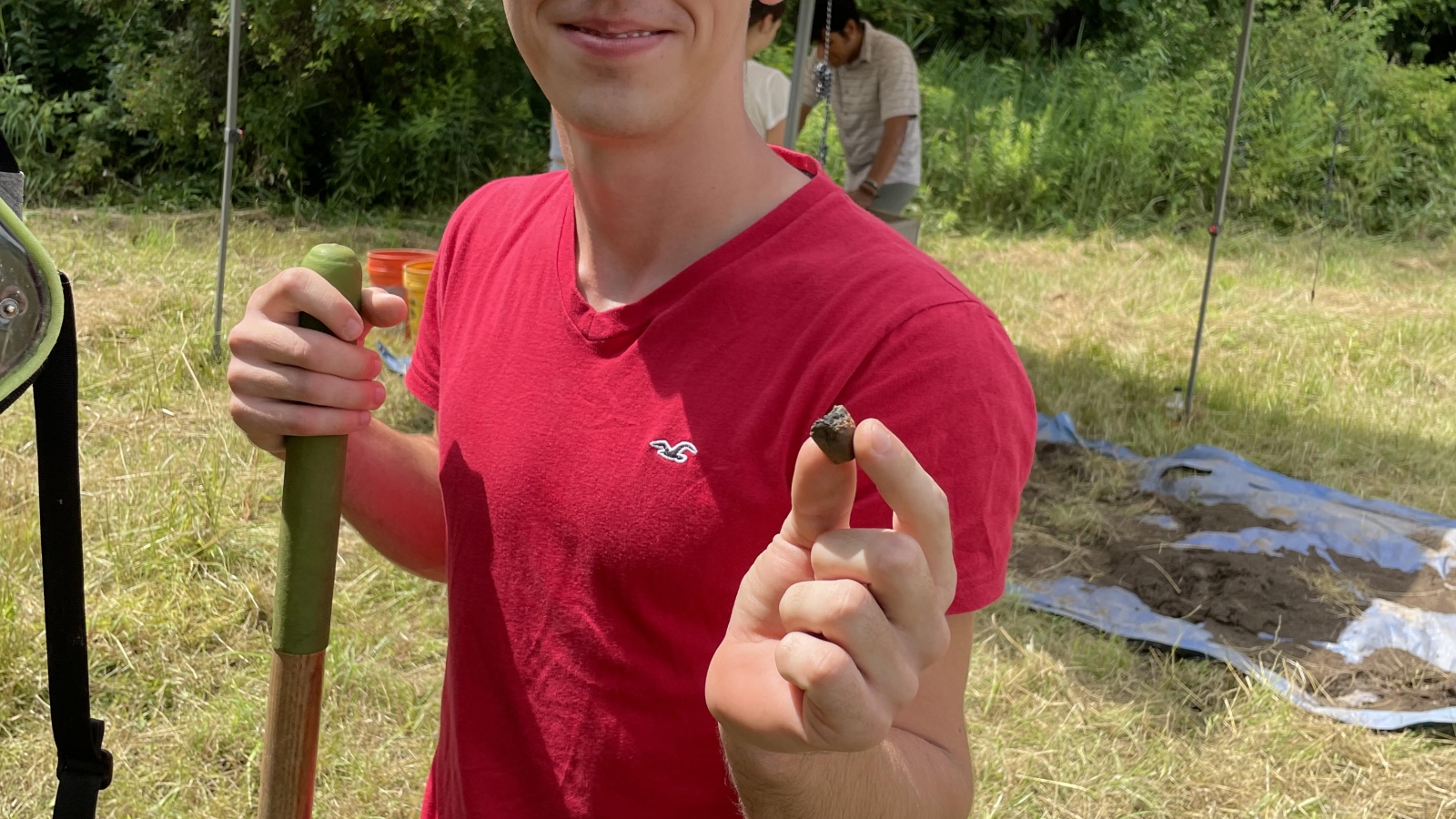 Volunteer holds 800 yr old ceramic pipe at Canticle Farms