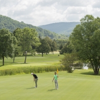 Guys golfing on Double Black Diamond golf course at Holiday Valley