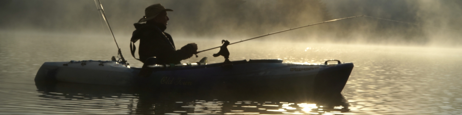 Fishing in a kayak on a lake at Allegany State Park