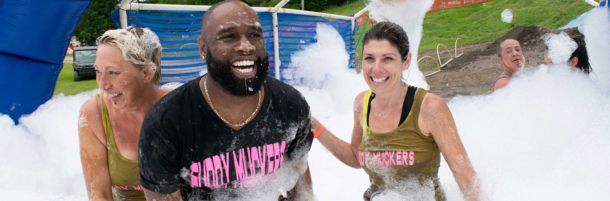 Runners at the Mudslide finish line with bubbles