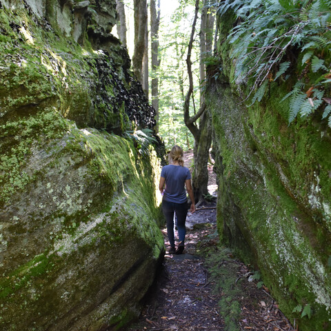 Hiker going through the rocks at Little Rock City