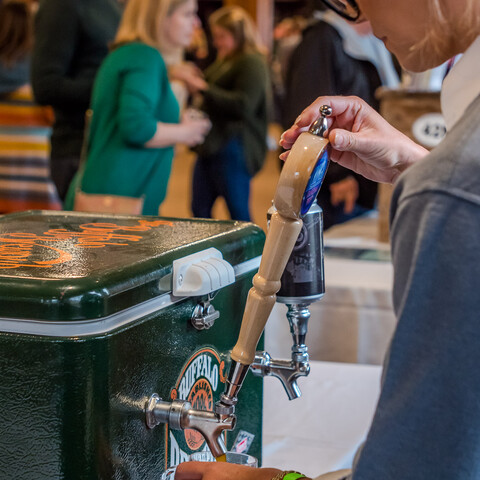 Woman pouring a drink at Holiday Valley's Beer and Wine Festival