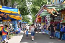 Fair goers walking through the games at the Cattaraugus County Fair