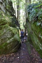 Hiker going through the rocks at Little Rock City